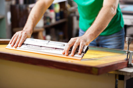 screenprinter with squeegee and green shirt